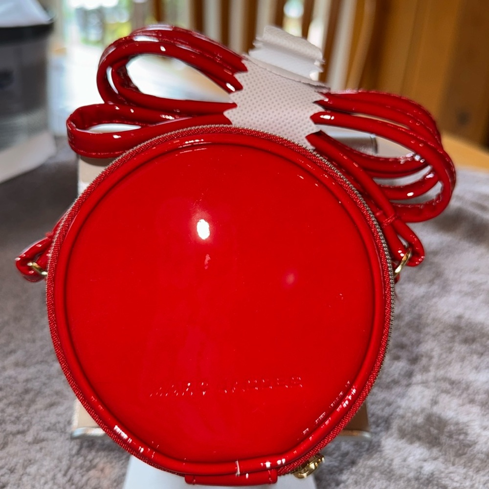 Marc Jacobs Deep Red Crossbody Bag with Glossy Finish. Canteen Shape
